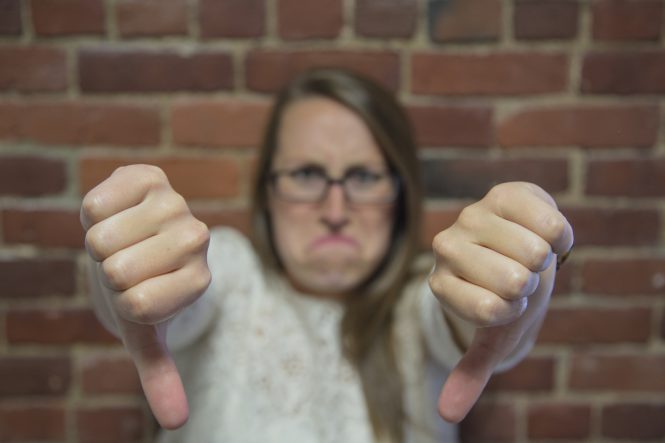 Unhappy woman with Thumbs down